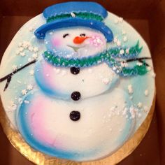 there is a frosted cake with a snowman on it