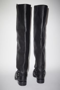 Acne Studios black high boots are crafted from leather, adorned with silver-toned metal hardware accents. Complete with stirrup strap details and debossed Acne Studios logo on the back. Leather Knee-high Moto Boots With Rivets, Leather High Boots, Black High Boots, High Leather Boots, Studio Logo, Stirrups, Leather Buckle, Metal Hardware, Boots Black