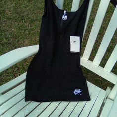 This Dress Is So Cute And Comfortable That You Will Soon Be Calling It Your Go To Little Black Dress. A Body Hugging Fit And U-Shaped Neckline And Half Zipper On The Front In Combination With Its Soft And Stretchy Jersey Like Material Makes This Dress Great For Day Or Night Time Play. The Main Color Is Black And There Is A Nike Emblem Embroidered Using White Threadz On The Front Of The Dress. Casual Stretch Dresses With Zipper, Casual Stretch Dress With Zipper Closure, Casual Fitted Dresses For Streetwear, Casual Cotton Dresses With Zipper Closure, Casual Cotton Dress With Zipper Closure, Casual Mini Dress With Zipper Closure, Black Athleisure Mini Length Dress, Black Mini Length Athleisure Dress, Black Athleisure Mini Dress