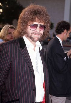 a man in a suit and sunglasses at an event