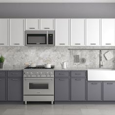 a kitchen with gray cabinets and white appliances