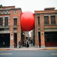 a large red object in the middle of a street