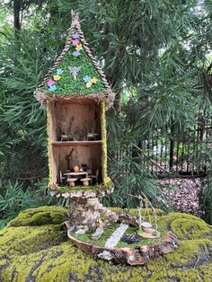 a fairy house made out of wood and moss