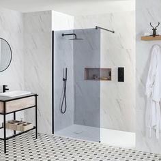 a bathroom with marble walls and flooring in black and white colors, including a walk - in shower