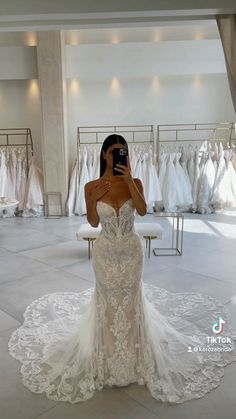 a woman taking a selfie in a wedding dress