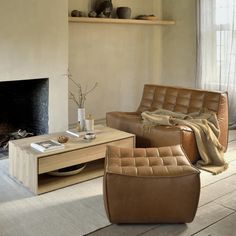 a living room filled with furniture and a fire place