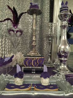 a table topped with purple and silver decorations