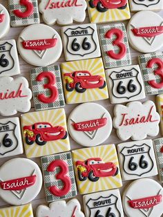 decorated cookies are arranged in the shape of cars and numbers for birthdays or special occasions