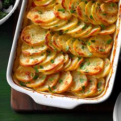 a casserole dish filled with potatoes and parsley