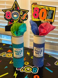 two cups filled with candy sitting next to each other on top of a black table