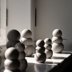 some rocks are stacked on top of each other in front of a window sill