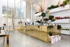 the interior of a flower shop with lots of flowers