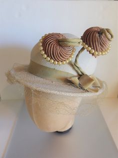 "Crazy cute off white panama straw hat from the 1930's with two jutting brown fabric florals on green stalks trimmed in faux pearls. The hat measures 20\" on the inside circumference and the crown of the hat is about 4\" high. Each flower measures 2\" in diameter and they stand up about 3\". It has a grosgrain ribbon bow. The hat is in great condition for its age with only tearing of the netting and some soiling of the inside rim. It is marked \" Genuine Panama\" on the inside band. Please email Handmade Fitted Vintage Fascinator, Vintage Cream Fascinator For Royal Ascot, Cream Vintage Fascinator For Royal Ascot, Handmade Vintage Hat Bands For Kentucky Derby, Vintage Adjustable Hat Bands For Kentucky Derby, Vintage Handmade Costume Hats And Headpieces, Handmade Vintage Hat Fascinator, Handmade Vintage Hat-style Fascinator, Handmade Vintage Costume Hats For Kentucky Derby