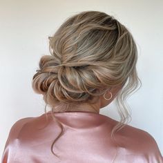 a woman with blonde hair in a low bun