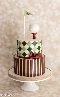 a decorated cake with a golf ball and flag on top