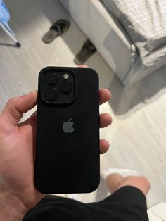 a person holding an apple phone in their hand with the camera on it's back