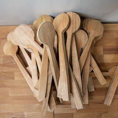 several wooden spoons are arranged on a table