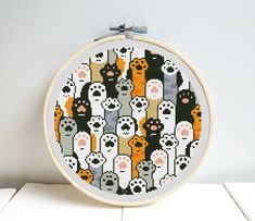 a cross stitch pattern with cats and kittens in the shape of a circle on a white background