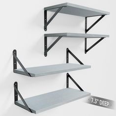 three metal shelves with brackets on each shelf