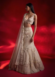 Step into sophistication with this ivory lehenga featuring exquisite 3D flower embellishments. The fish-cut silhouette, paired with a matching blouse and dupatta, creates a graceful and opulent look that's perfect for any elegant occasion. Intricate Embroidered Lehenga For Wedding Reception, Elegant Lehenga With Dupatta For Wedding Reception, Elegant Lehenga With Intricate Embroidery For Wedding Reception, Elegant Festive Lehenga For Wedding Reception, Traditional Floor-length Lehenga For Wedding Reception, Mermaid Cut Lehenga, Floor-length Lehenga With Intricate Embroidery For Wedding Reception, Elegant Cream Organza Lehenga, Anarkali Style Lehenga For Wedding Reception