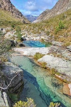 the water is blue and clear in this mountain stream