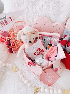 a teddy bear sitting in a pink basket filled with items