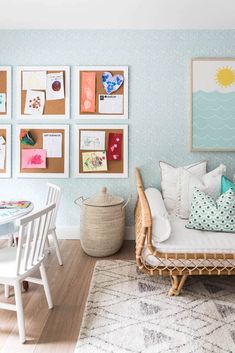 a living room filled with furniture and pictures on the wall