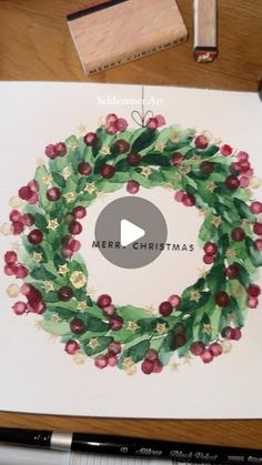 a christmas wreath drawn on top of a piece of paper