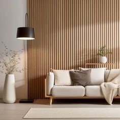 a living room scene with focus on the couch and rugs in front of the wall