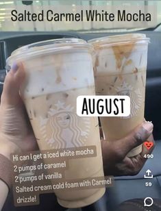 two cups of iced coffee sitting next to each other on a car dashboard with the caption, salted caramel white mocha