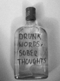 a glass bottle with writing on it that says drunk words sobr thoughs in black and white