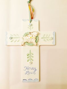 a cross with a lamb on it and the words henry & ruth written in blue