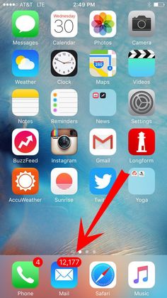 an iphone with the home screen open and icons on it, as well as a red arrow