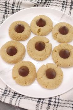 chocolate - covered cookies on a plate ready to be eaten