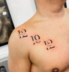 a man's chest with numbers on it