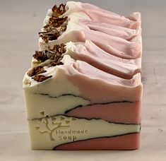 four bars of handmade soap sitting on top of each other