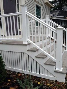 a white railing and hand rail on a porch