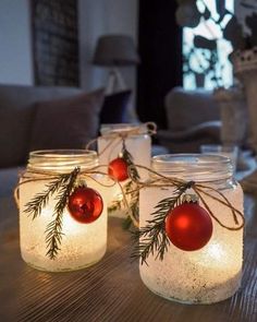 three mason jars filled with christmas ornaments on a table