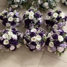 purple and white bridal bouquets laid out on the floor