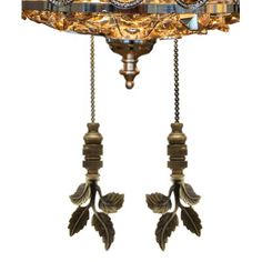 an ornate lamp hanging from the ceiling with two leaves attached to it's sides