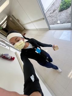 a woman with a bandaged head wearing a face mask and holding onto a pair of scissors