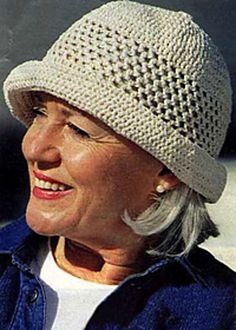 an older woman wearing a knitted hat