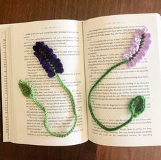 an open book with crocheted flowers on it