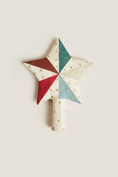 an ornament shaped like a star on a white surface