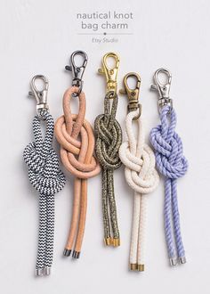 four different colored rope key chains with metal hooks on each side and one knot at the end