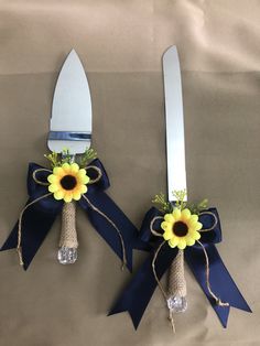 two forks decorated with sunflowers and blue ribbon