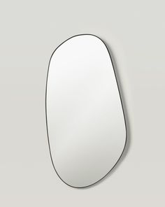 an oval shaped mirror on the wall