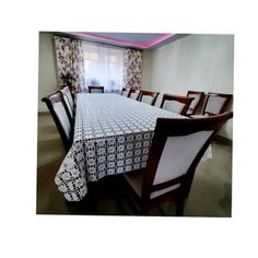 a dining room table and chairs in front of a window