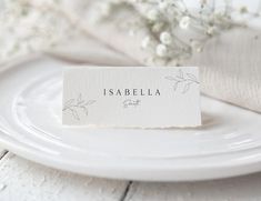 a place card sitting on top of a white plate