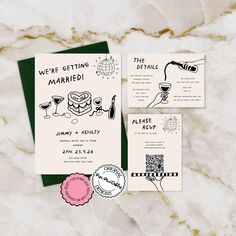 the wedding stationery is laid out on a marble surface with wine glasses and other items